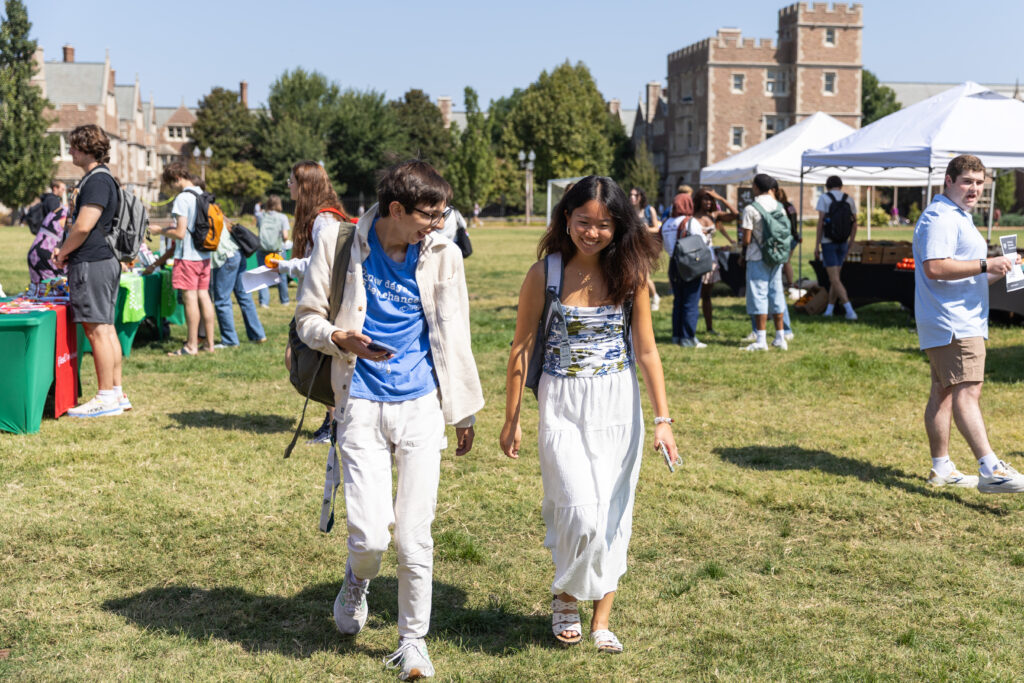 Two students walking in a field